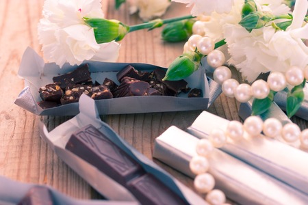 Chocolate with white flowers in foil. tonedの写真素材