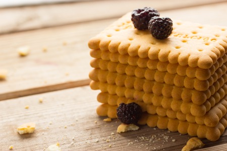 sweet dry yellow cookies on wooden backgroundの写真素材