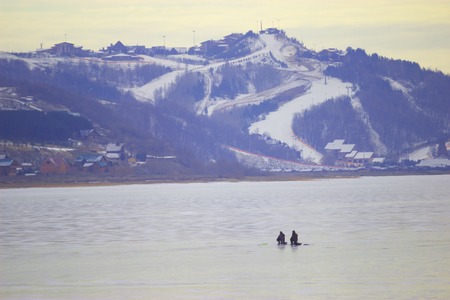 Frozen River and distant mountains, winter cold dayの写真素材