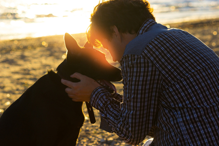 man and his dog on the beach. best friendsの写真素材