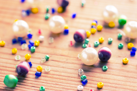 colorfuld beads on wooden table. close upの写真素材