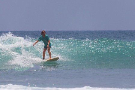 10.04.2017: Sri Lanka, Mirissa: Single surfer at sunset in the ocean with wavesのeditorial素材