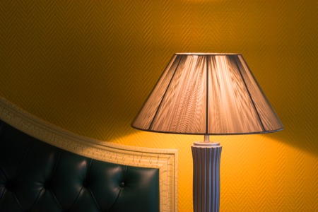 Desk Lamp with Bed. yellow wallpaper backgroundの写真素材