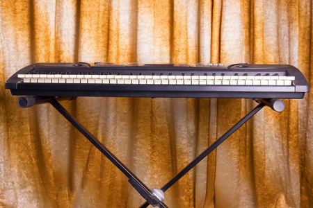 Electronic musical keyboard synthesizer close-up. yellow backgrounの写真素材