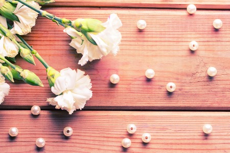 white flowers and beads on wooden background. copy spaceの写真素材