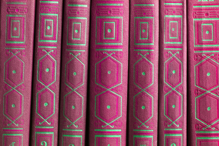 Old books on a wooden shelf. No labels, blank spine.の写真素材