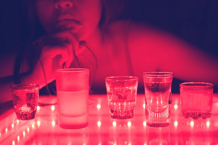 attractive girl in a bar with shot of alcohol