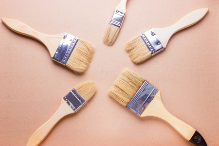 new different size paintbrushes on wood floorの写真素材