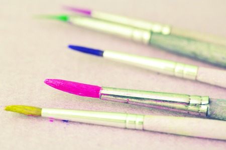 Row of artist paintbrushes closeup on white background.の写真素材