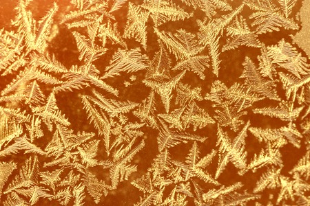 beautiful frosty pattern on glass winter windowの写真素材