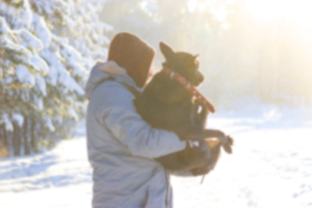 man take dog on his arm, because the dog is ill. winterの写真素材