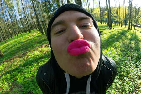 funny young men with pink lips. fisheye lensの写真素材