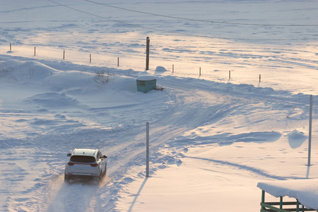 off-road car in winter. on a field covered with snowの写真素材