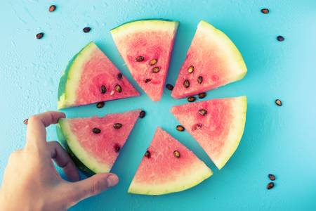 slice of ripe water melon in handの写真素材