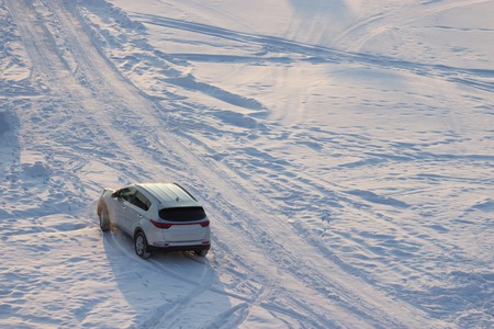 off-road car in winter. on a field covered with snow