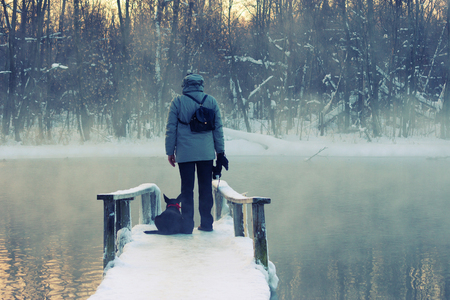man and his dog standing on a bridge. loneliness suicide conceptの写真素材