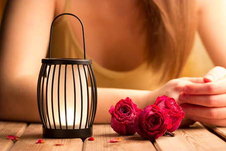 girl on a date sitting by the table. candle rosesの写真素材