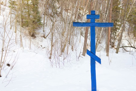 Cross on a tree in the winter forest. scary pictureの写真素材