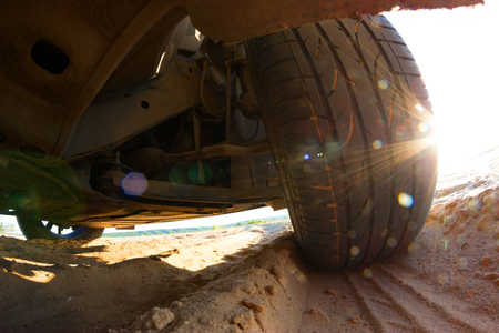 view under big off-road car on sandの写真素材