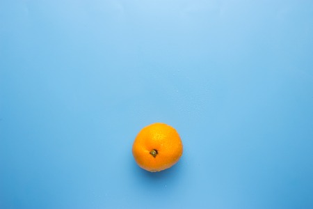 Fresh orange on blue background. copy spaceの写真素材