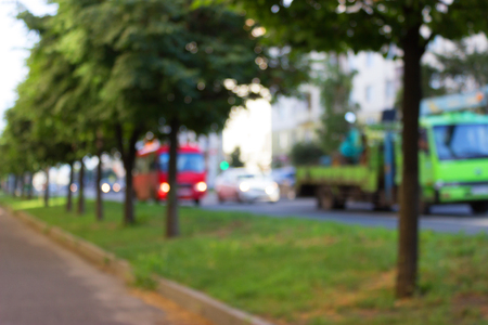 Blur traffic road with green trees on a sideの写真素材