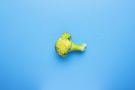 Raw and fresh healthy broccoli cabbage on blue backgroundの写真素材