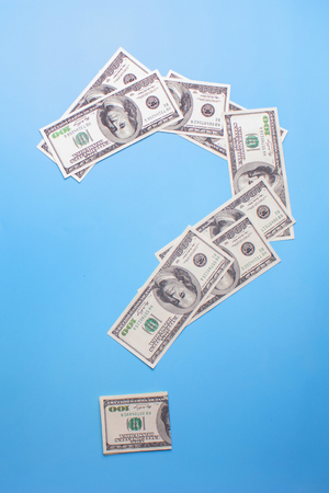 dollar in a form of question mark on blue backgroundの写真素材
