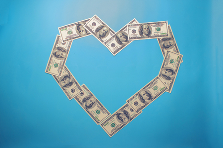 Heart shape sign with 100 dollar banknotes. Valentine concept backgroundの写真素材