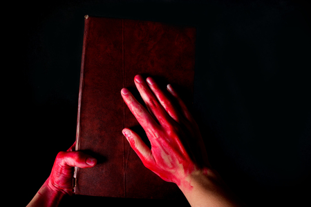 Alchemy book with bloody hand. halloween conceptの写真素材