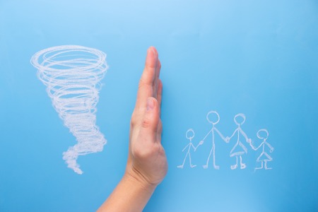 Protecting Family concept hand protect family from tornadoの写真素材