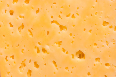 Cheese surface with openings close up textureの写真素材