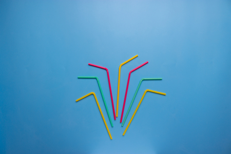 colorful cocktail tubes with copy space on blue backgroundの写真素材