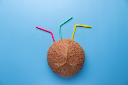 Coconut drink on blue background. with colorful cocktail rollsの写真素材