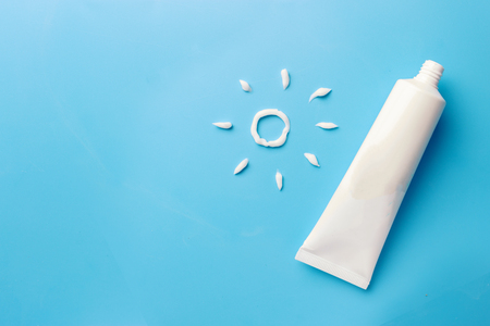 Sunscreen on blue background. relax on the beach concept