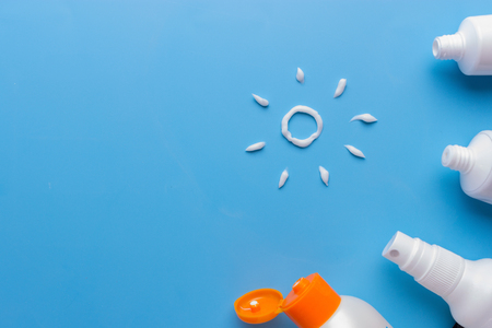 Sunscreen on blue background. relax on the beach conceptの写真素材
