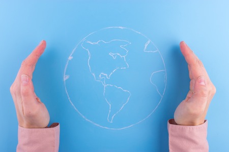 Woman hands holding earth. Save the earth concept.の写真素材