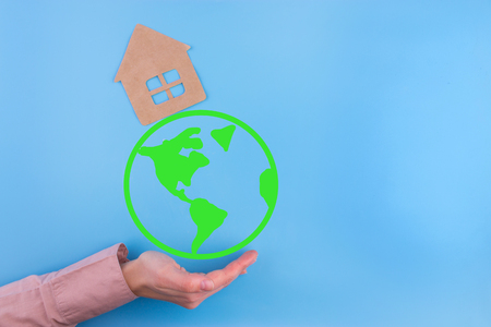 Paper cut of eco house on blue backgroundの写真素材