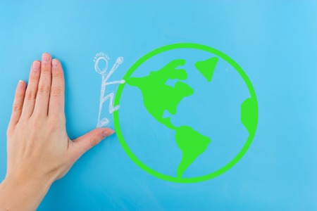 man hiking on the earth hand helping himの写真素材