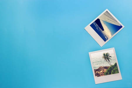 Opened summer holiday journey photo on blue backgroundの写真素材