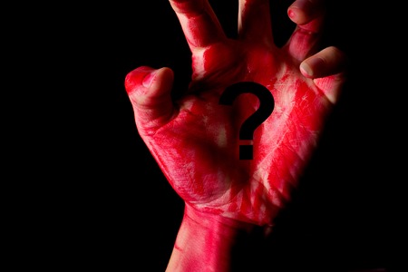 innocent or guilty concept. bloody hand on black backgroundの写真素材