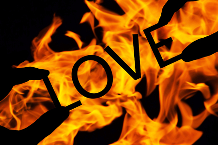 text love with hands over fire backgroundの写真素材