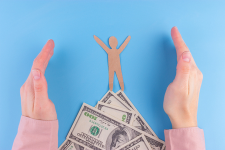 cartoon character stand on mountain made from moneyの写真素材