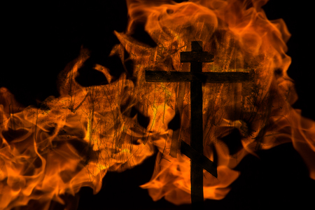 cross in the fire on black backgroundの写真素材