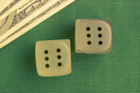 two dice with number six on each on green background