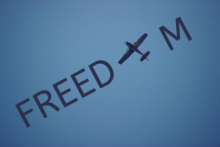 airplane in the blue sky . freedom conceptの写真素材