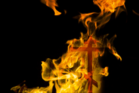cross in the fire on black backgroundの写真素材