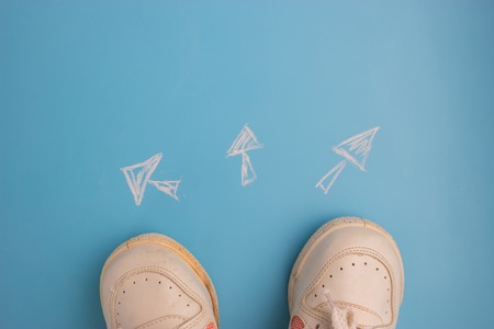 Where to go concept. sneakers on blue backgroundの写真素材