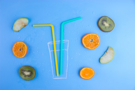 fresh fruits on blue background. kiwi oranges appleの写真素材