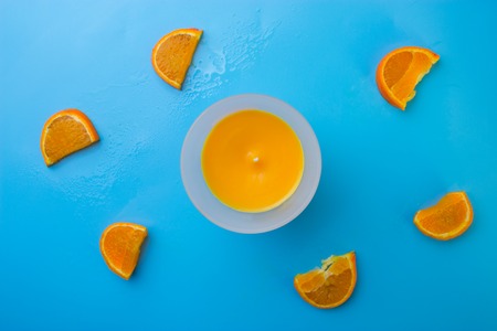 orange aroma candle on the blue backgroundの写真素材