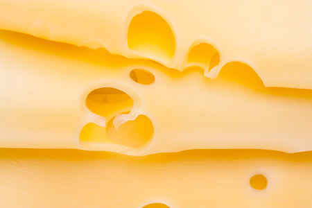 Slices of cheese close up. yellow cheese backgroundの写真素材